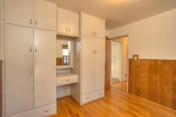 a view of walk in closet with empty racks