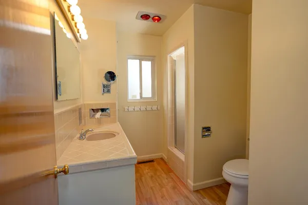 a bathroom with a sink toilet and shower