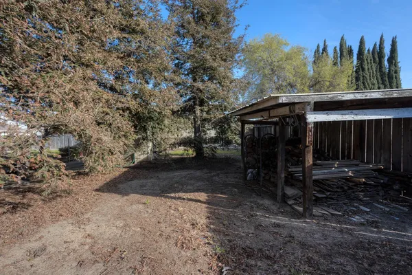 a view of a chair and table on the side of the road