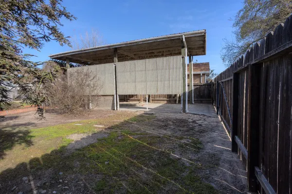 a backyard of a house with table and chairs