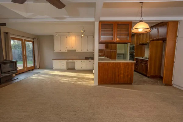 a view of a room with wooden floor and windows