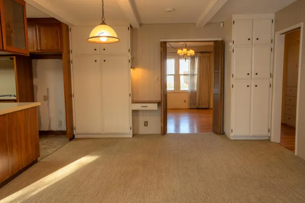 an empty room with windows and entrance