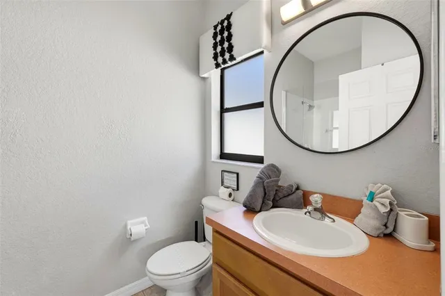 a bathroom with a sink a toilet and a mirror