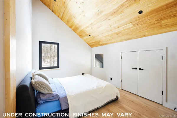 a bedroom with a bed and a night stand