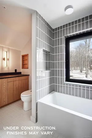 a bathroom with a toilet a sink and bathtub