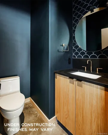 a bathroom with a toilet and a mirror