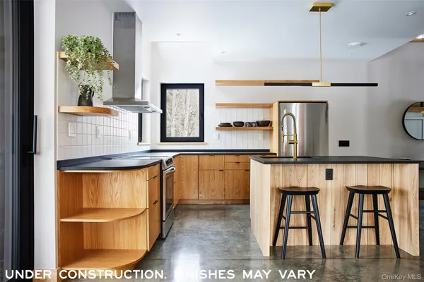 a kitchen with stainless steel appliances kitchen island granite countertop a refrigerator and microwave