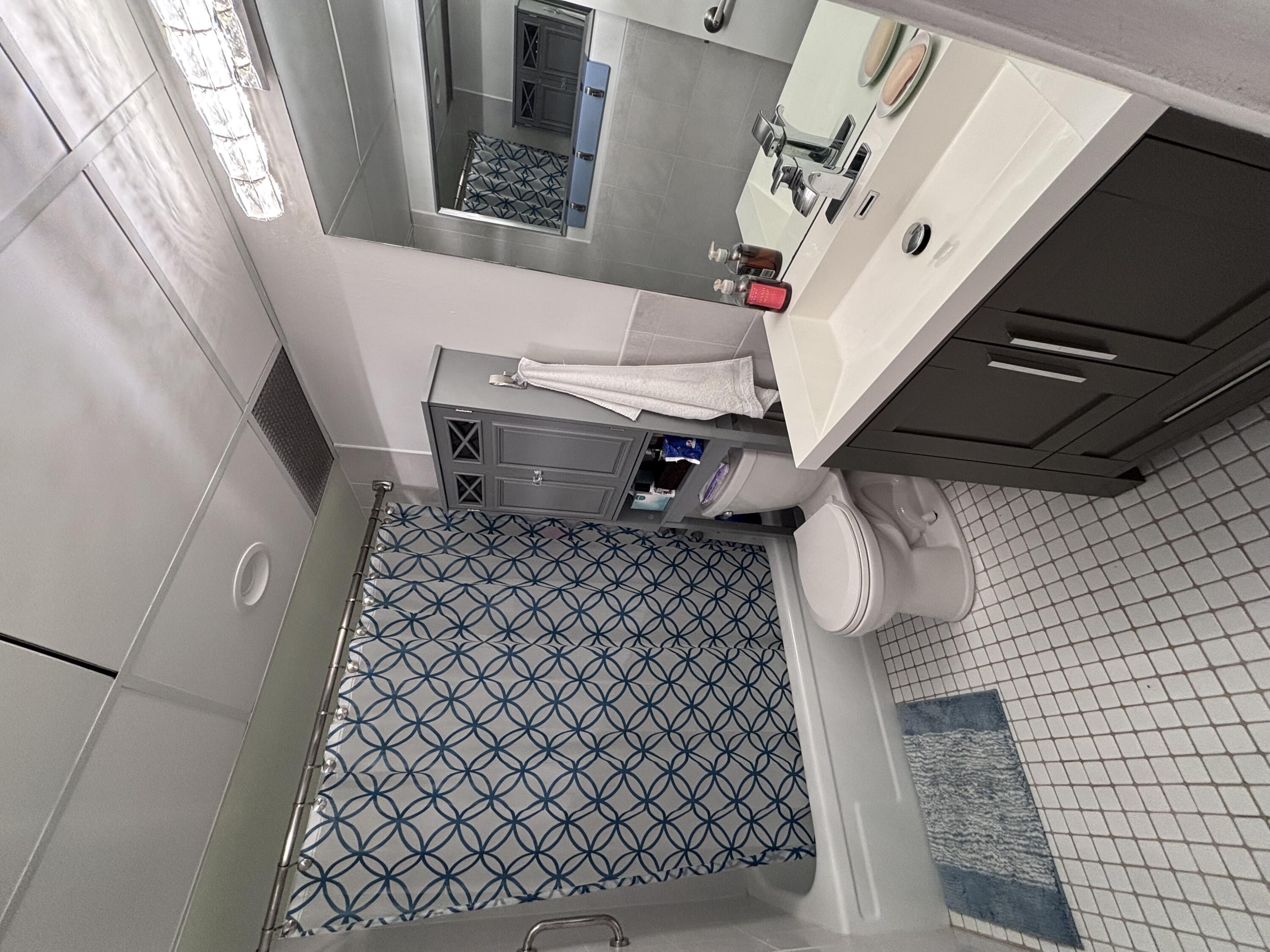 336 North Birch Road, Unit 8D Fort Lauderdale, FL 33304 - Photo 13 of 25 a bathroom with a toilet and a shower curtain