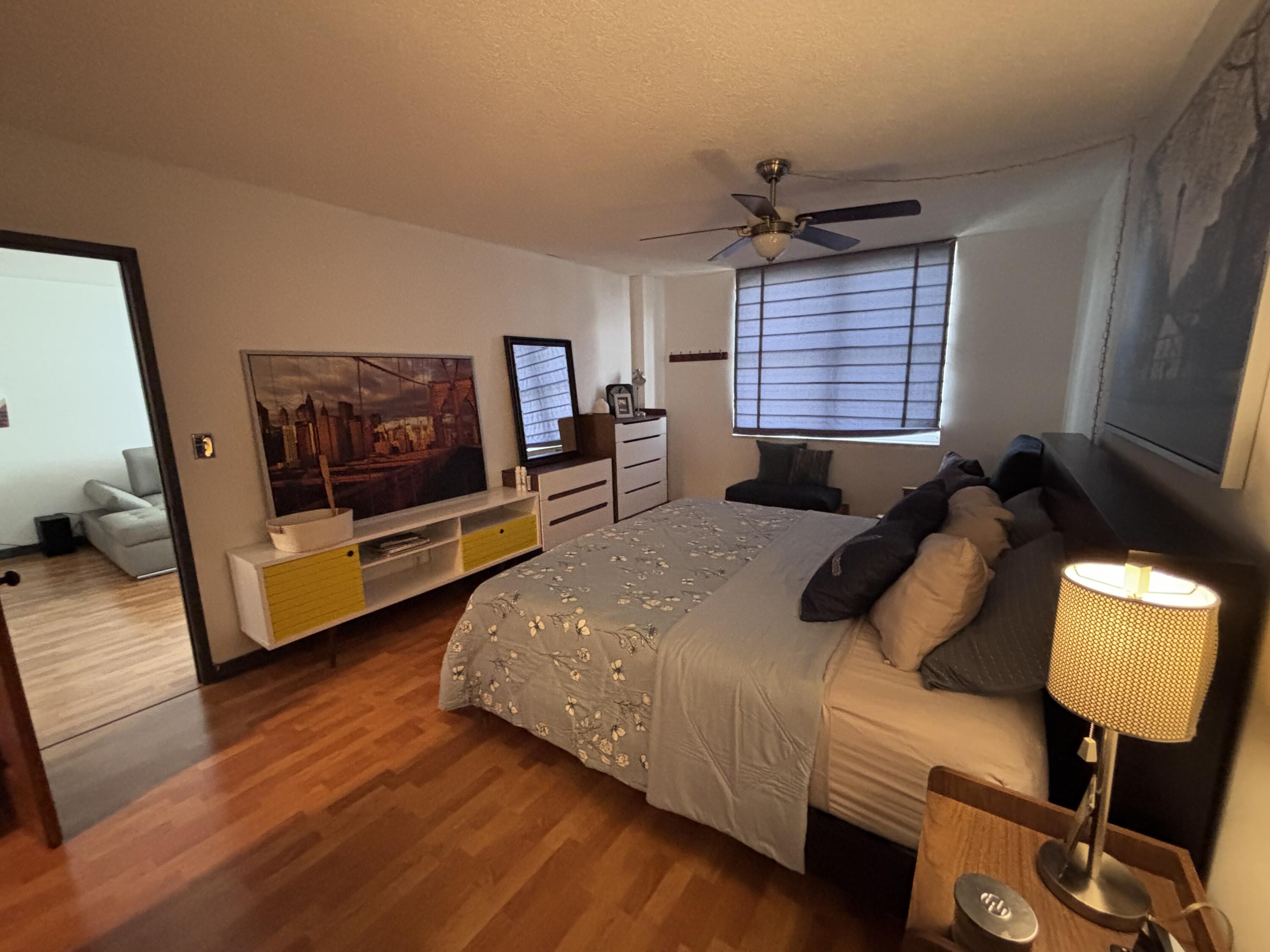 336 North Birch Road, Unit 8D Fort Lauderdale, FL 33304 - Photo 15 of 25 a spacious bedroom with a bed a couch and a window