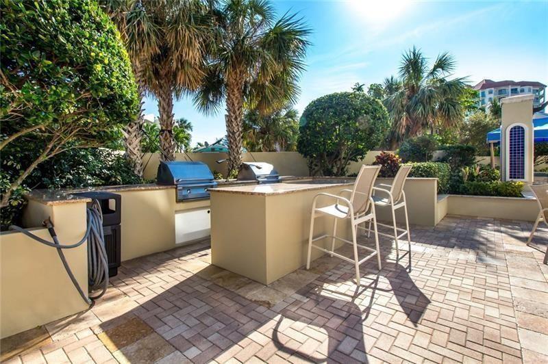336 North Birch Road, Unit 8D Fort Lauderdale, FL 33304 - Photo 5 of 25 a view of a patio with a table and chairs