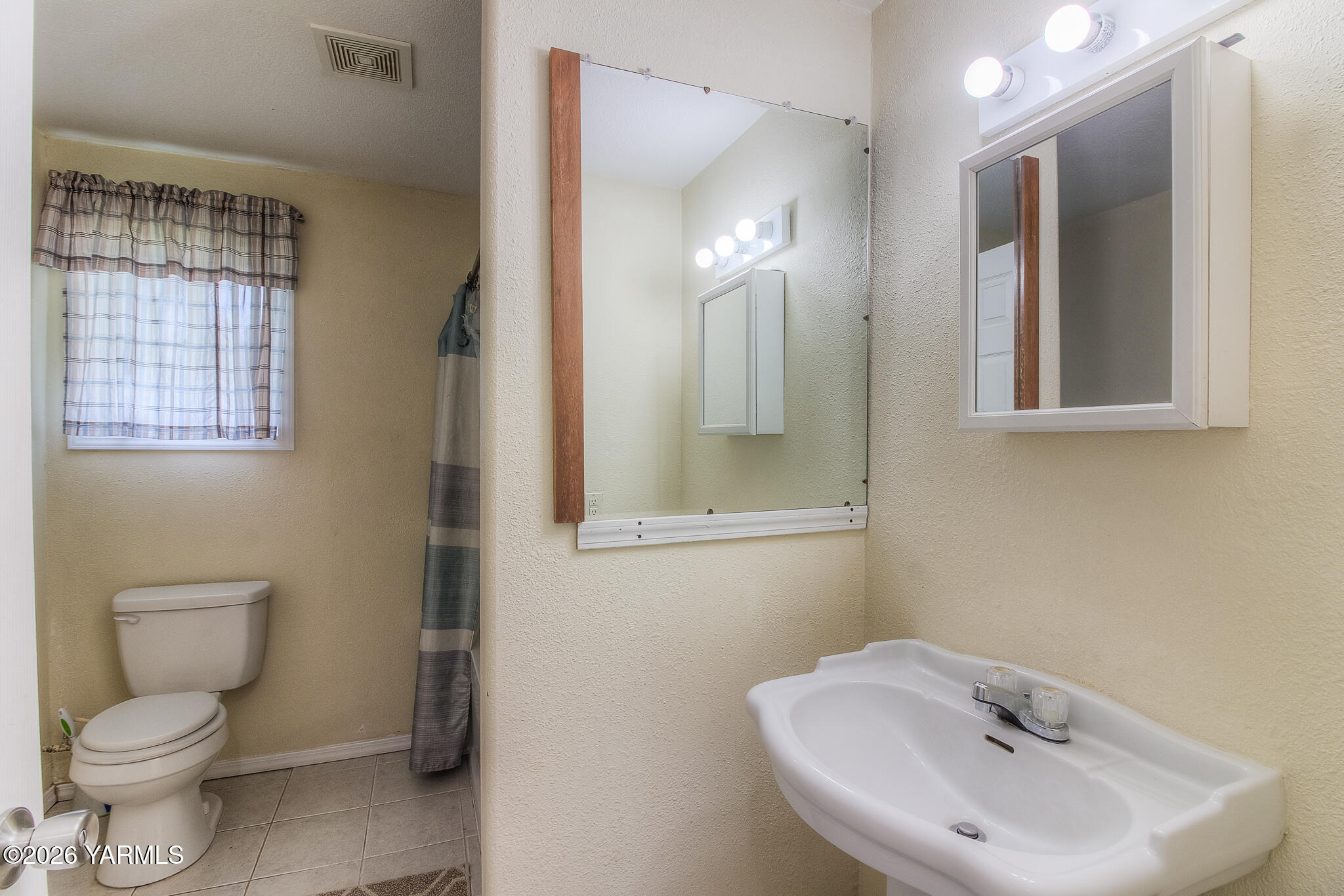 130 Green Giant Road Mabton, WA 98935 - Photo 15 of 34 a bathroom with a toilet sink and mirror