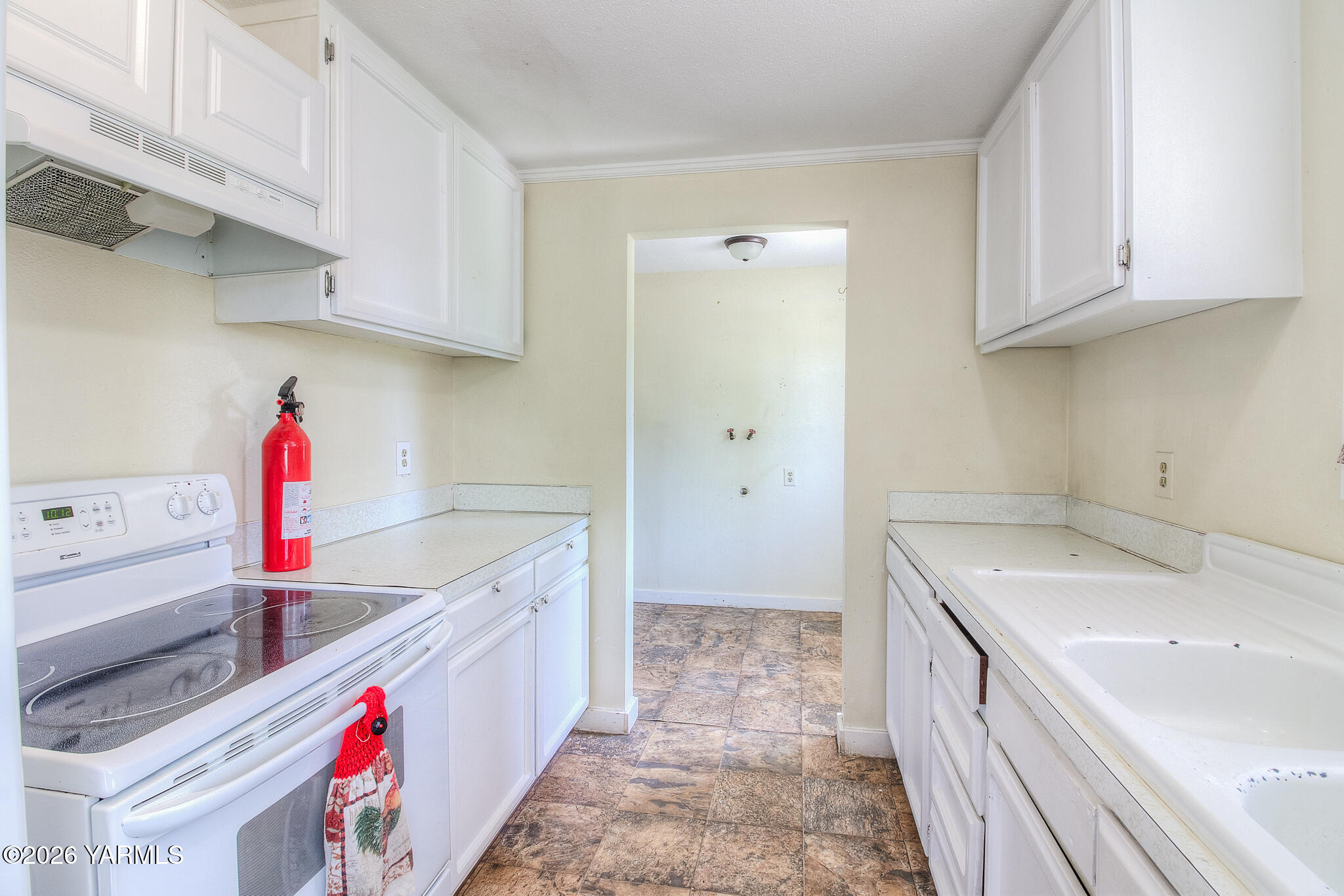 130 Green Giant Road Mabton, WA 98935 - Photo 23 of 34 a kitchen with a sink stove and cabinets