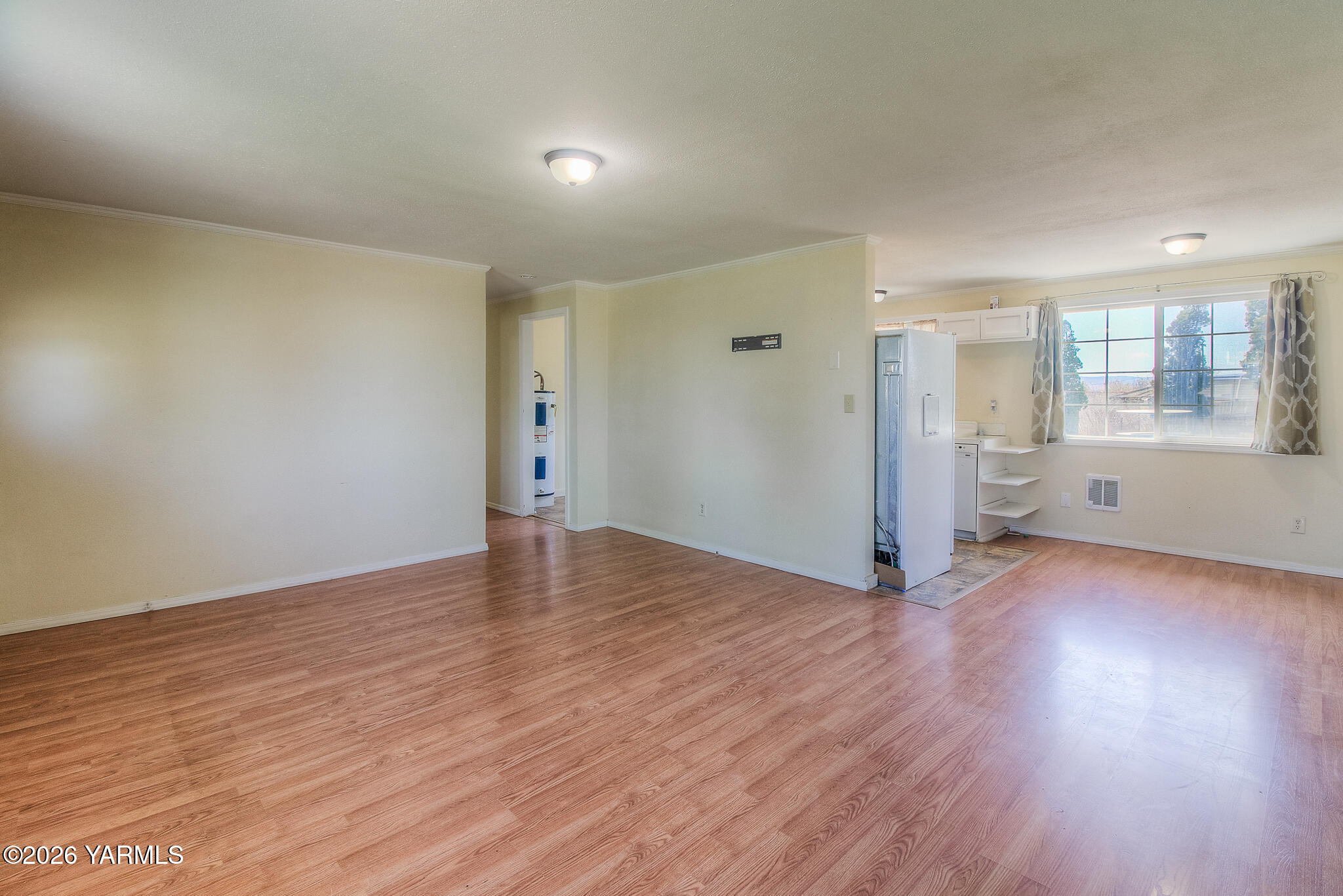 130 Green Giant Road Mabton, WA 98935 - Photo 8 of 34 an empty room with wooden floor and windows