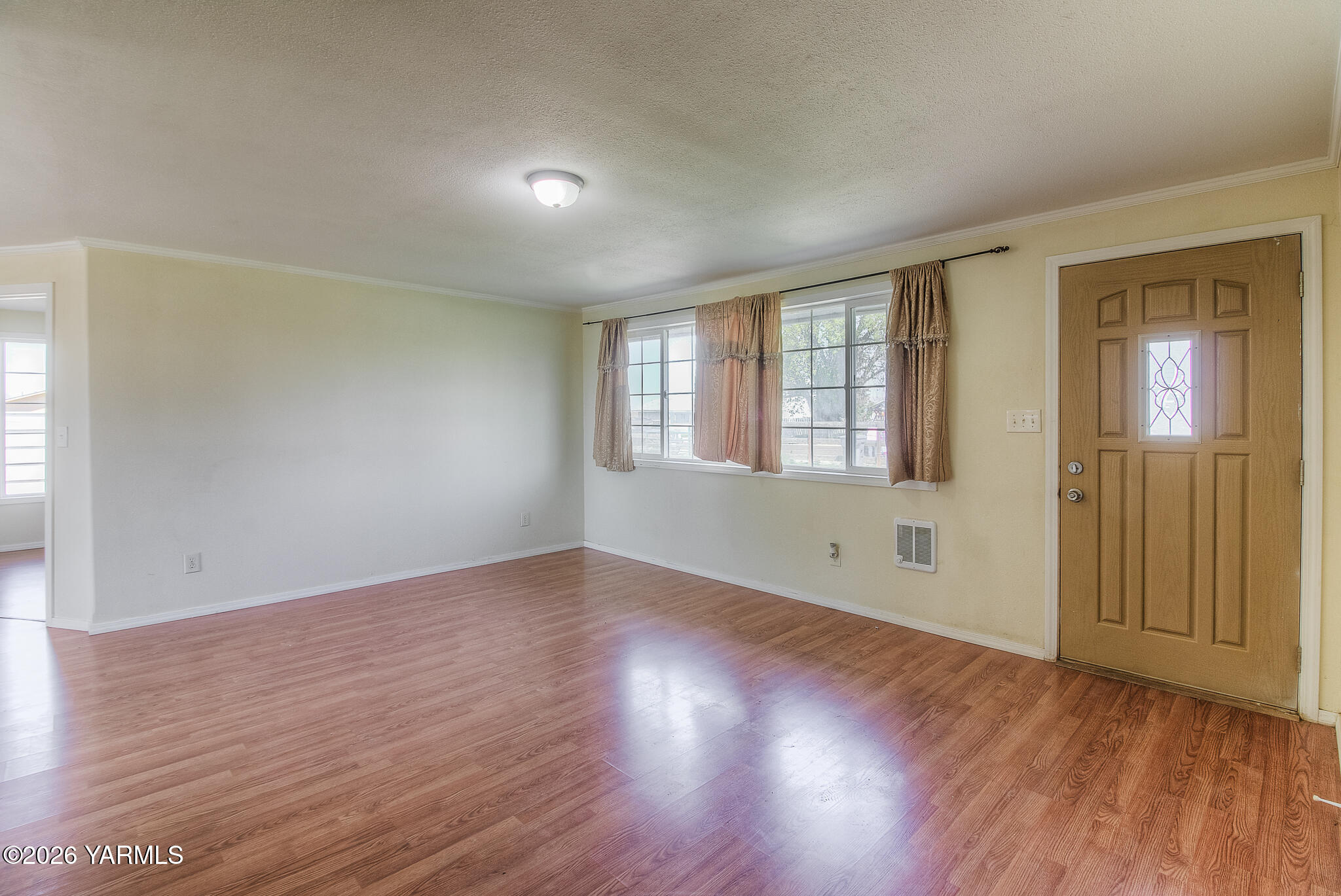 130 Green Giant Road Mabton, WA 98935 - Photo 9 of 34 an empty room with wooden floor and windows