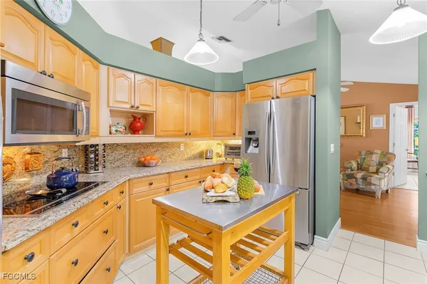 a kitchen with stainless steel appliances a stove a sink and a refrigerator