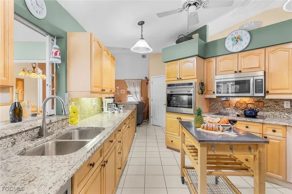 a kitchen with stainless steel appliances a stove a sink and a refrigerator