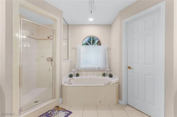 a white bath tub sitting in a bathroom and shower