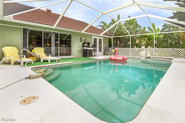 a view of a backyard with table and chairs and potted plants