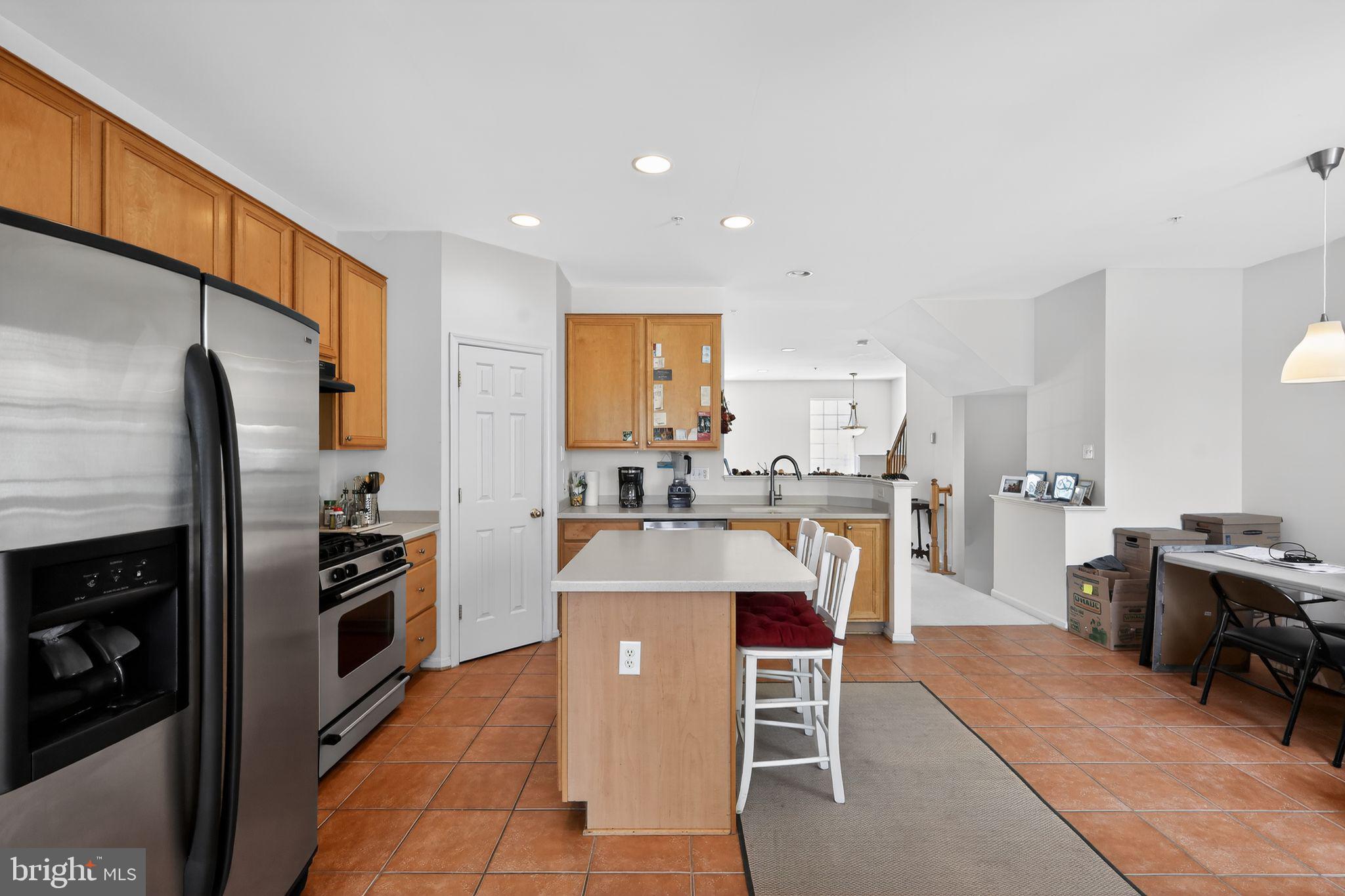 1034 Meandering Way Odenton, MD 21113 - Photo 11 of 30 a large kitchen with a table and chairs in it
