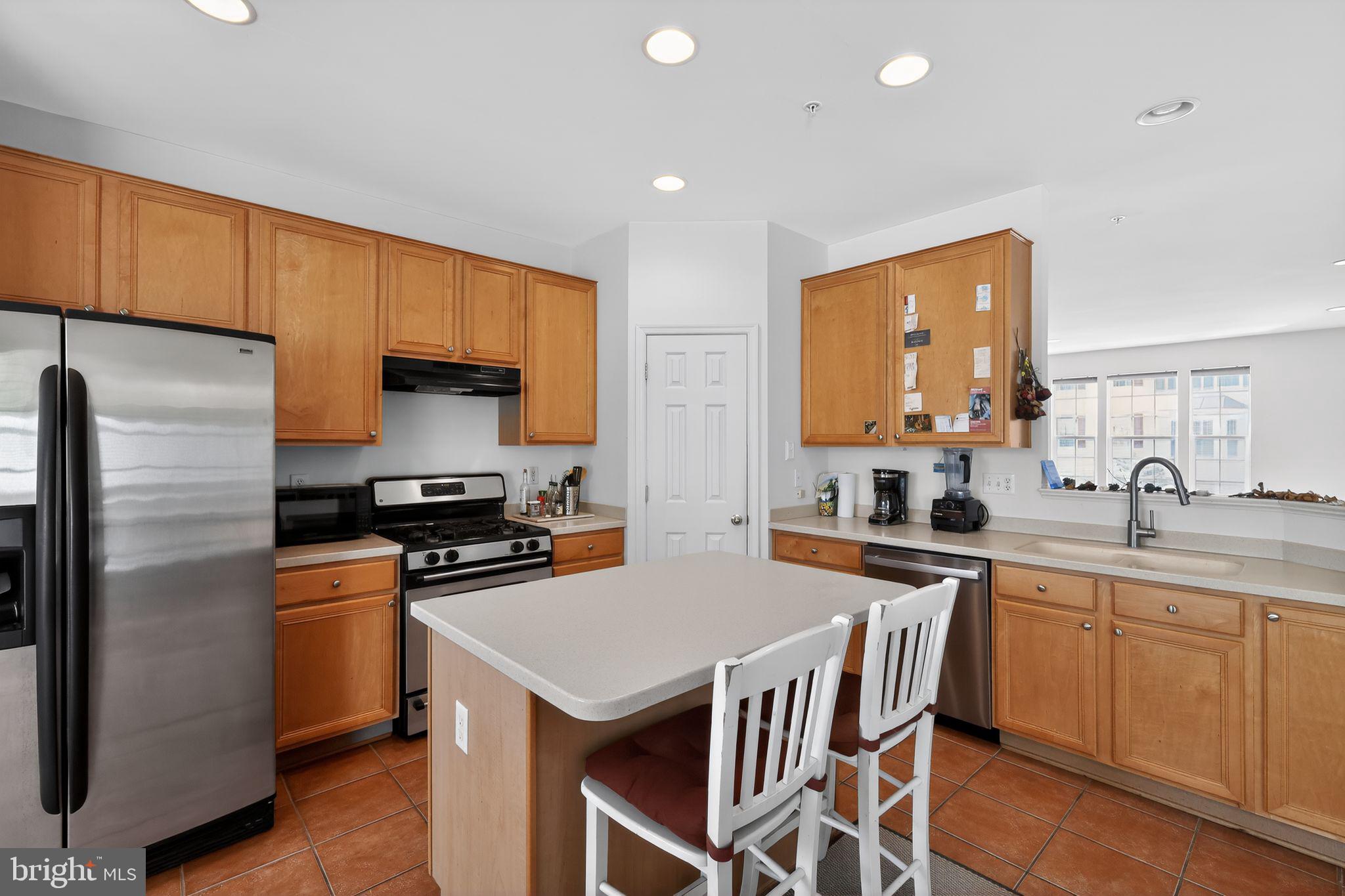 1034 Meandering Way Odenton, MD 21113 - Photo 12 of 30 a kitchen with a sink a stove a refrigerator cabinets and a dining table