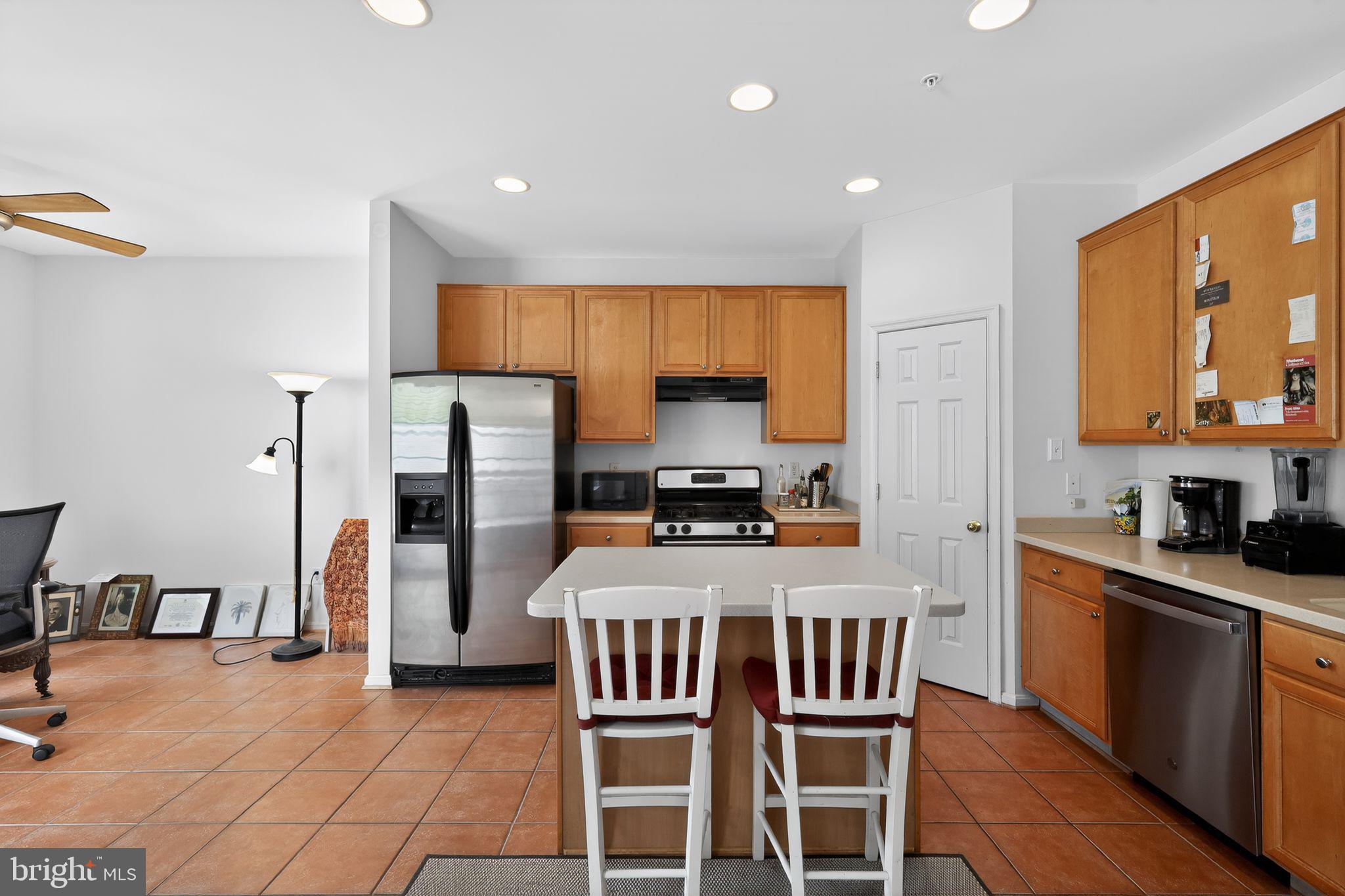1034 Meandering Way Odenton, MD 21113 - Photo 14 of 30 a kitchen with a sink a stove a refrigerator cabinets and dining table