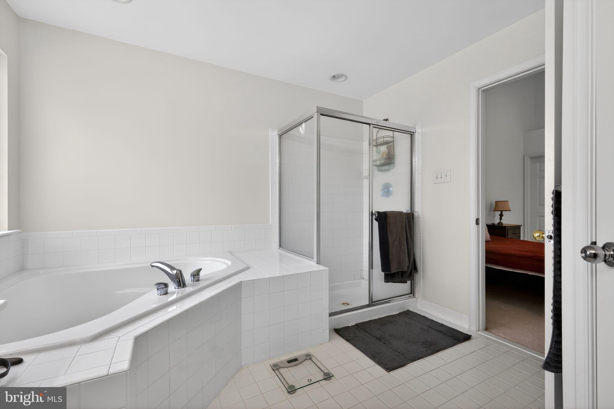 1034 Meandering Way Odenton, MD 21113 - Photo 24 of 30 a bathroom with a bathtub and a shower