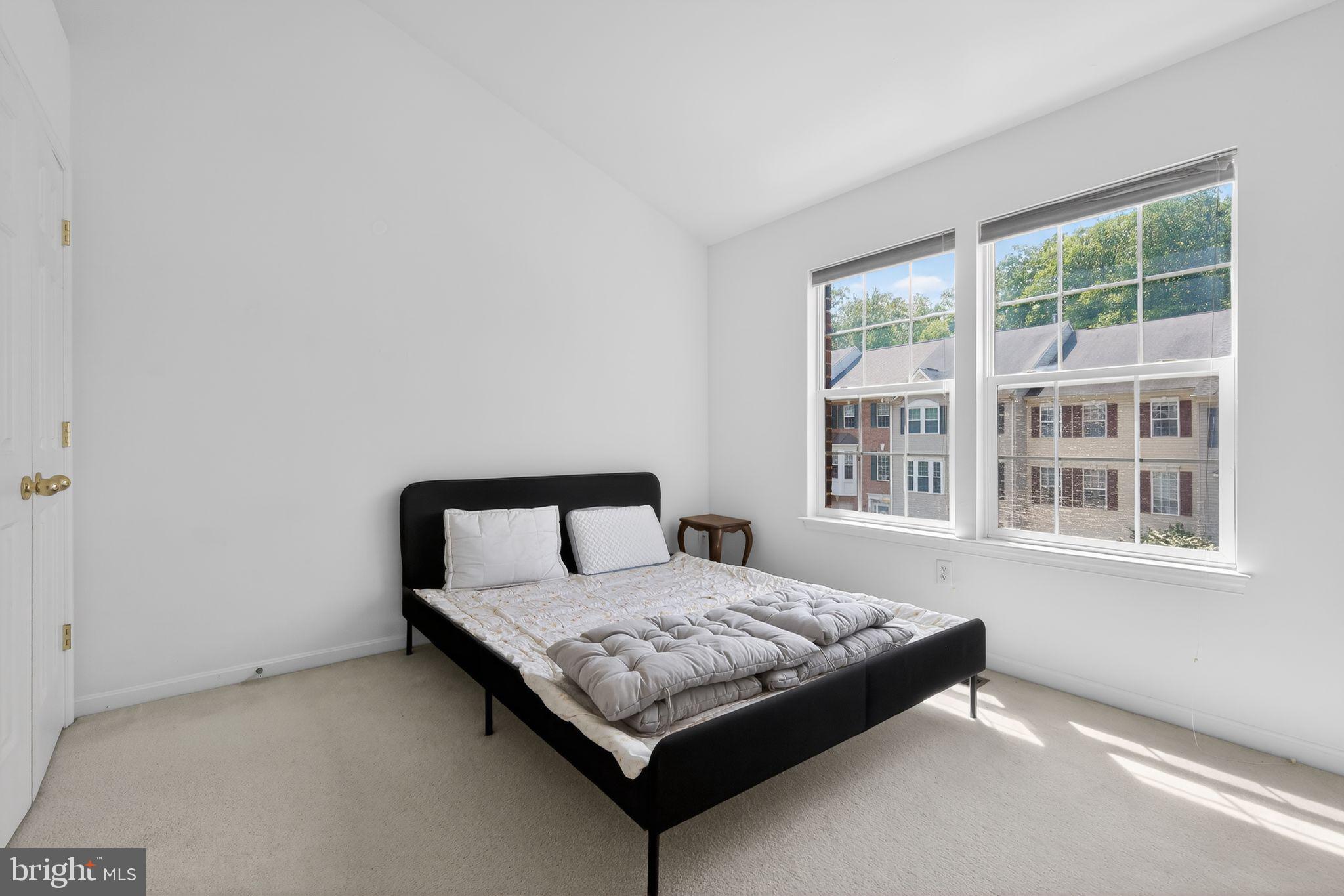 1034 Meandering Way Odenton, MD 21113 - Photo 26 of 30 a large bed sitting in a bedroom next to a window
