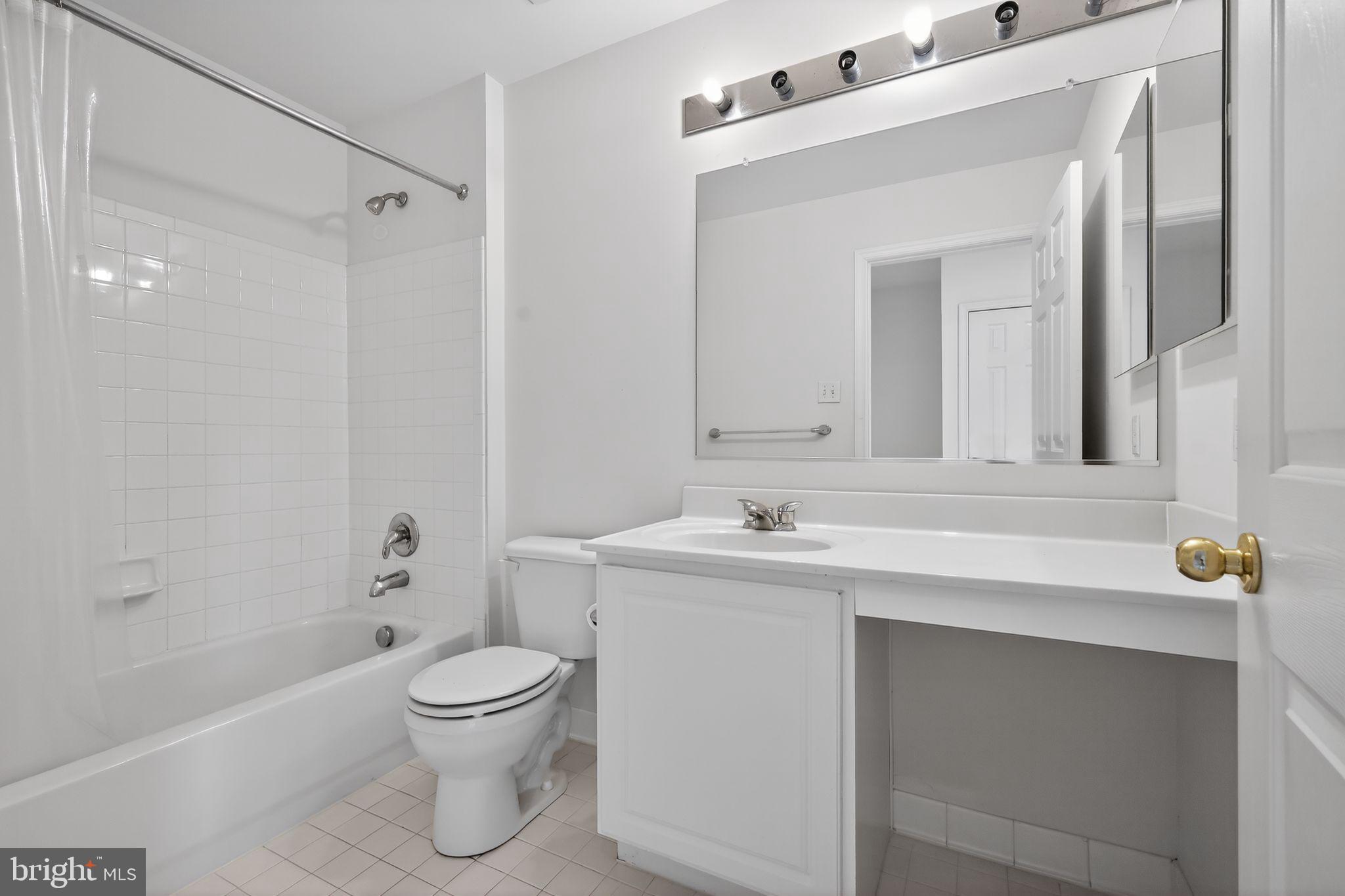 1034 Meandering Way Odenton, MD 21113 - Photo 30 of 30 a bathroom with a toilet sink a mirror and shower