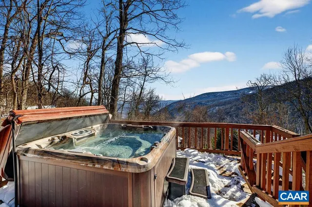 a view of a wooden deck with furniture and a fire pit