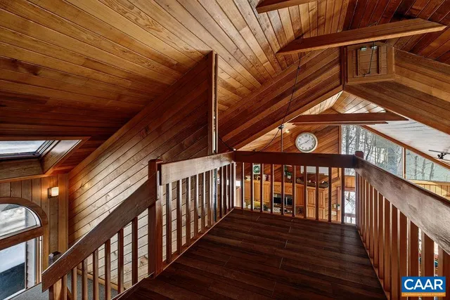 a bedroom with bed and wooden floor