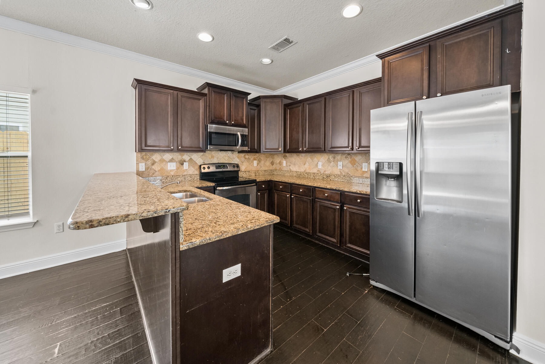 41 Hackberry Way Santa Rosa Beach, FL 32459 - Photo 20 of 27 a kitchen with stainless steel appliances granite countertop a refrigerator a stove a sink and a microwave
