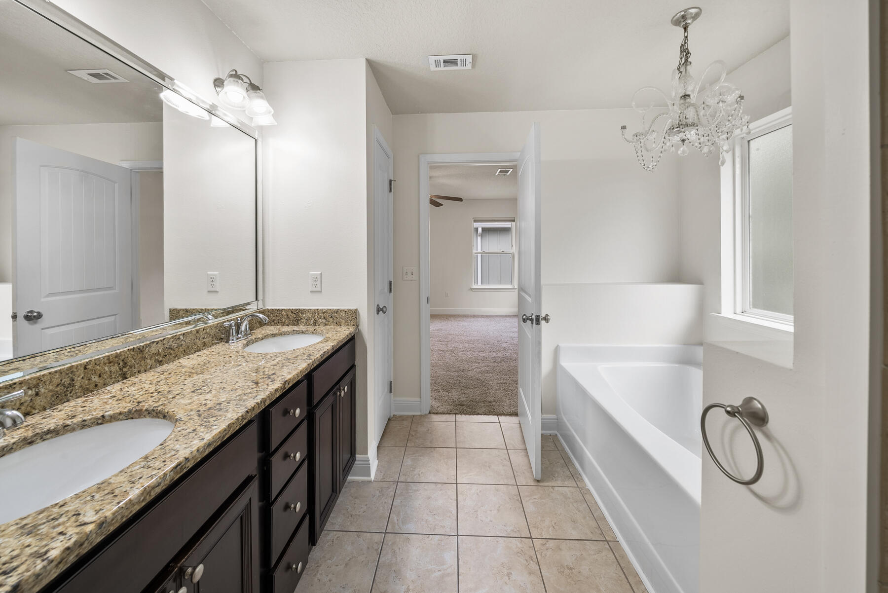 41 Hackberry Way Santa Rosa Beach, FL 32459 - Photo 9 of 27 a bathroom with a granite countertop sink a large mirror and a bathtub