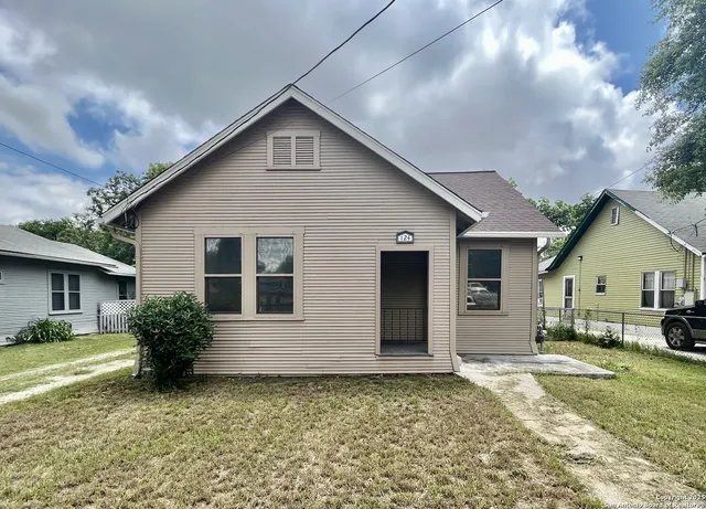 a front view of a house with a yard table and chairs