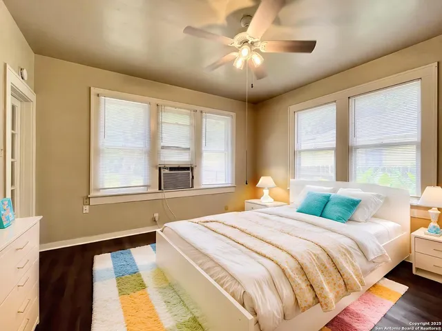 a bedroom with a large bed and a large window