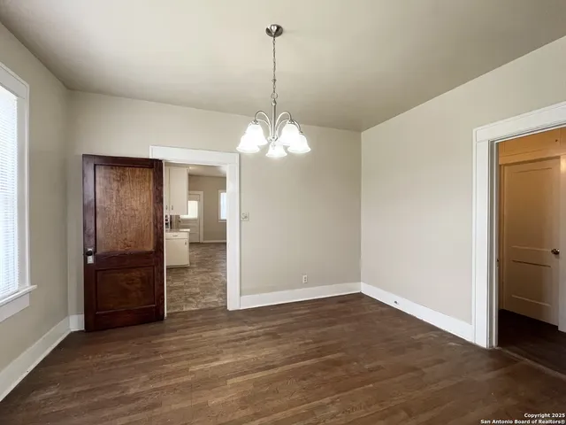 a view of a livingroom with a chandelier fan and closet