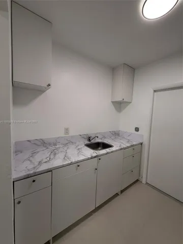 a kitchen with a sink and a stove