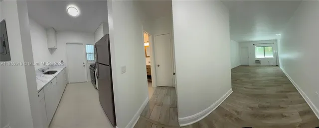 a view of a hallway with a room