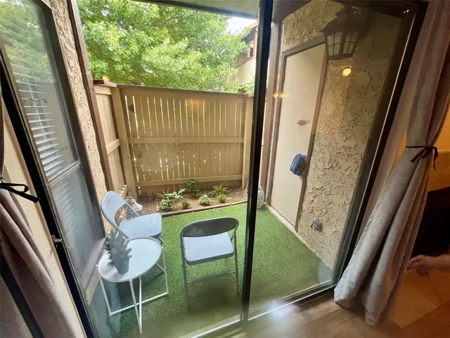 a view of a balcony with furniture and a bath tub