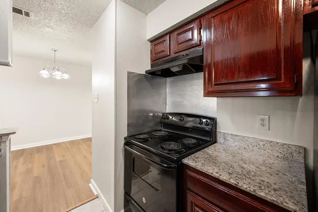 a kitchen with stainless steel appliances granite countertop a stove and a microwave