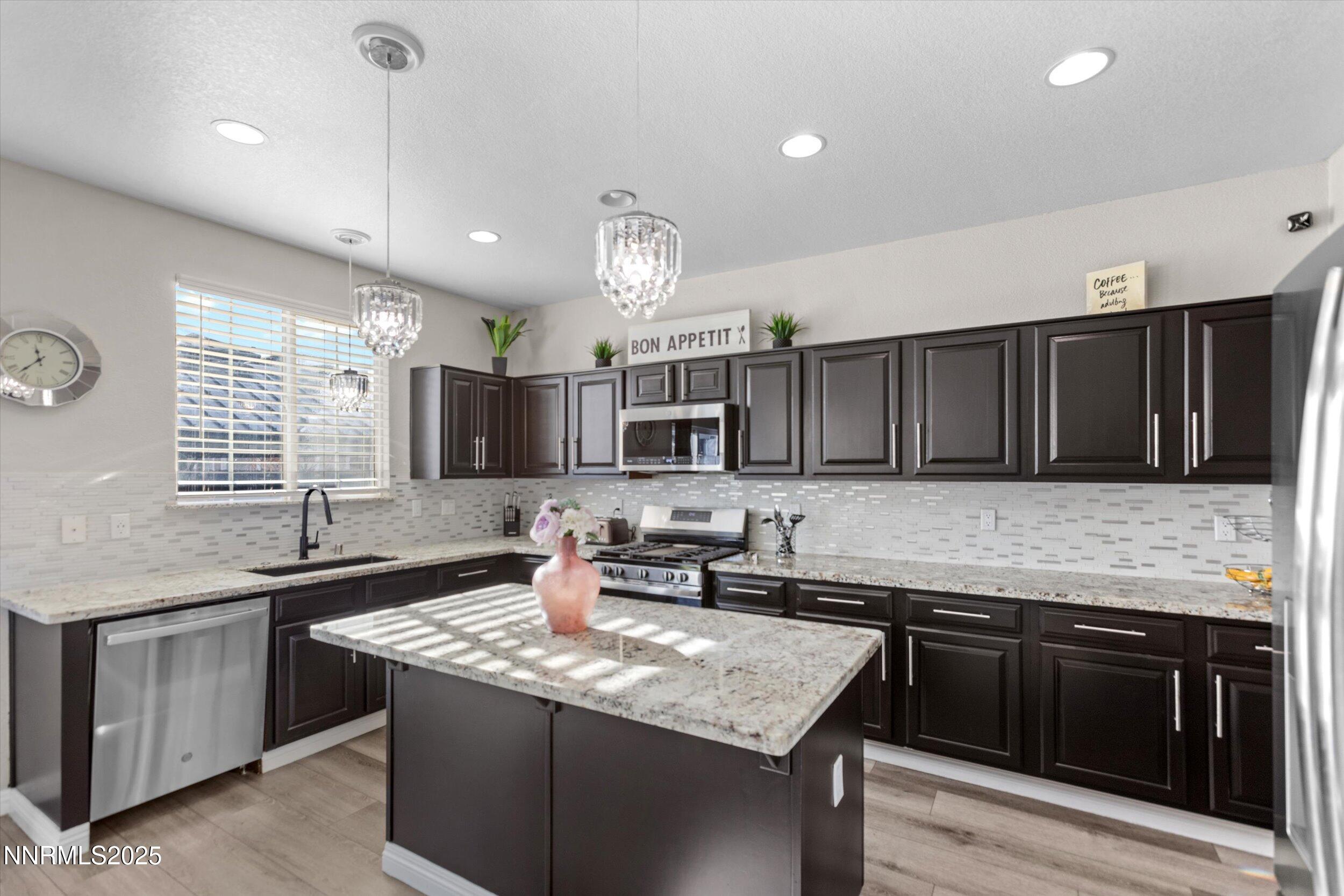 8922 Sorcha Street Reno, NV 89506 - Photo 12 of 47 a kitchen with stainless steel appliances granite countertop a sink stove and cabinets