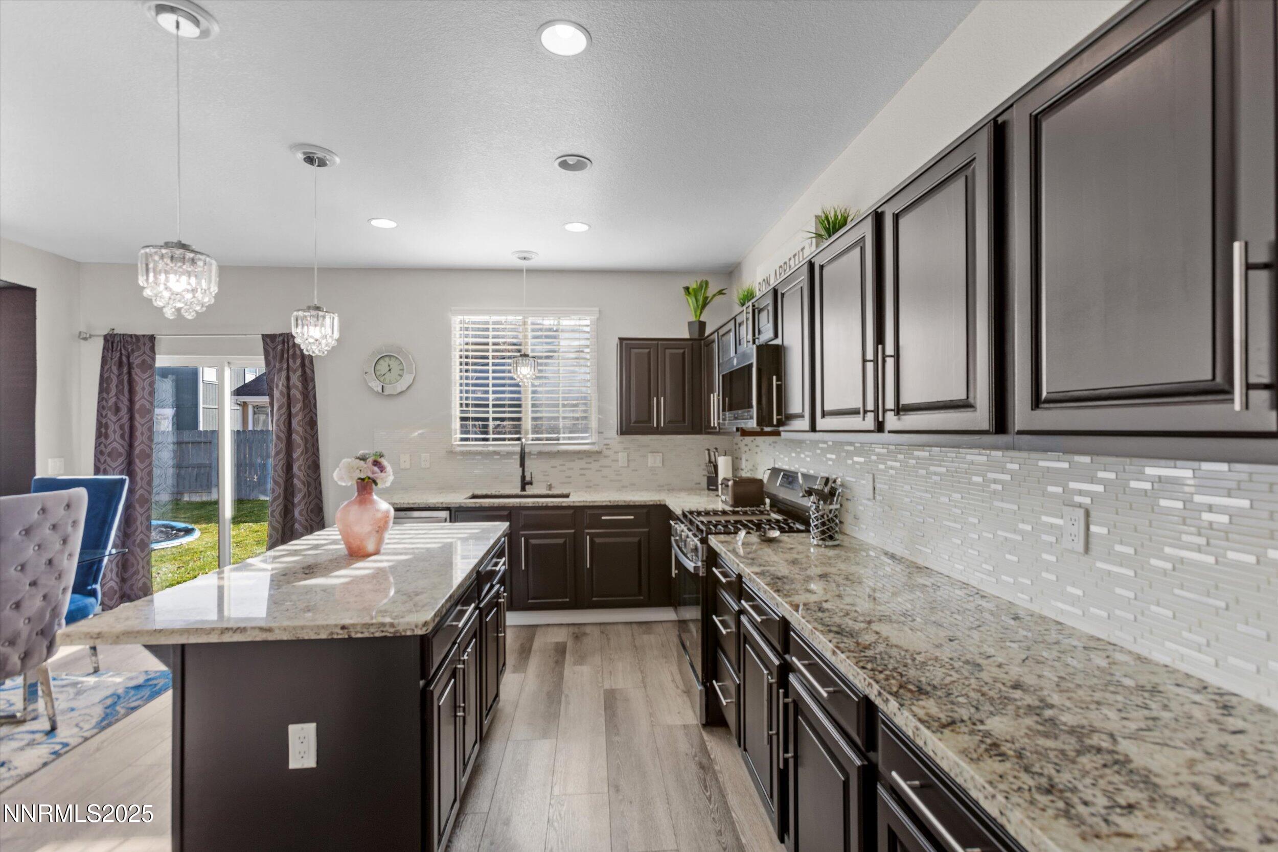 8922 Sorcha Street Reno, NV 89506 - Photo 13 of 47 a large kitchen with a stove and large sink