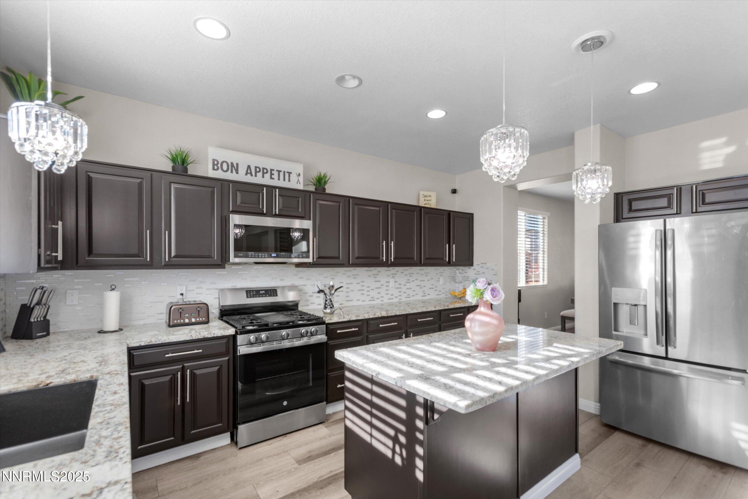 8922 Sorcha Street Reno, NV 89506 - Photo 16 of 47 a kitchen with a stove a sink and a refrigerator