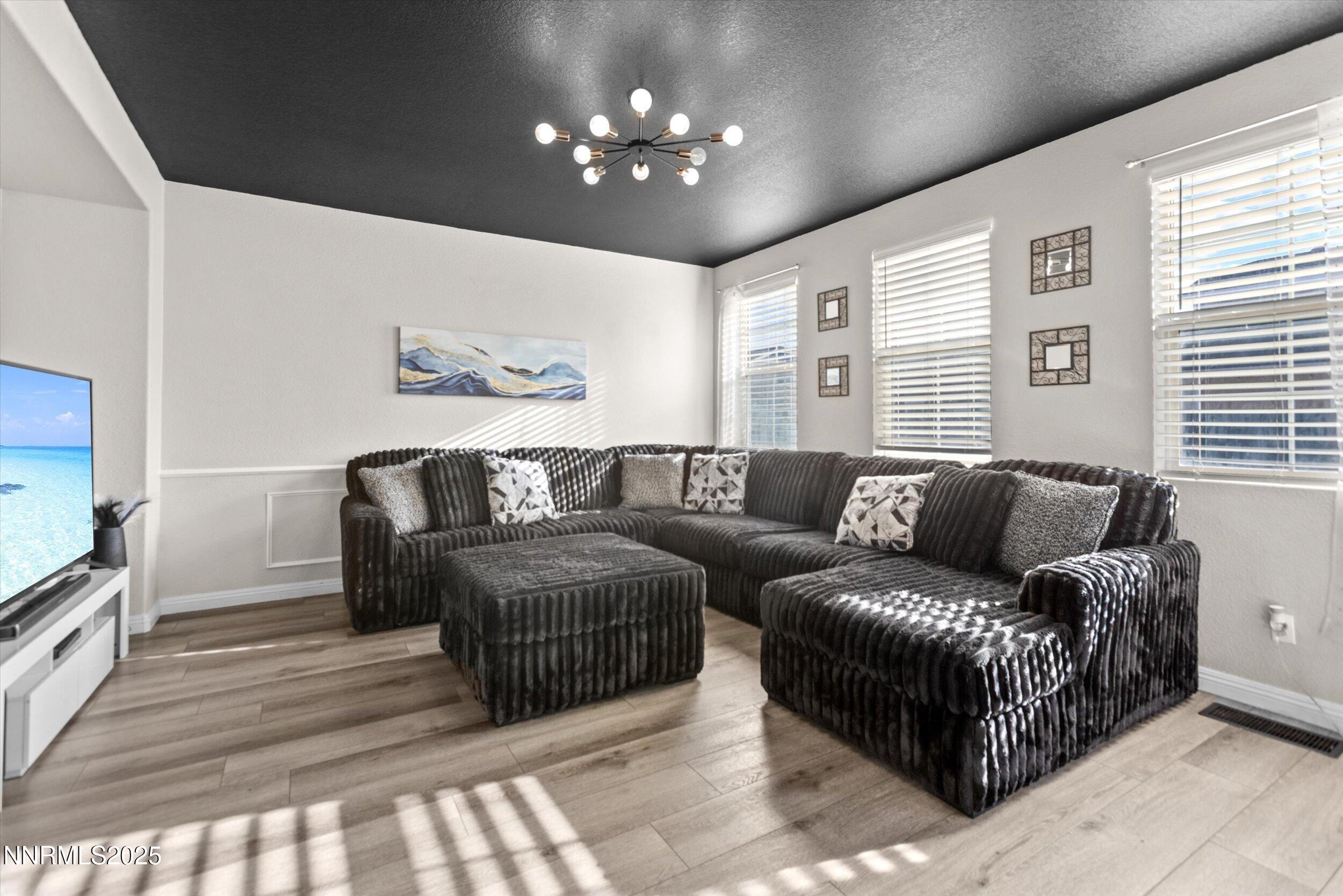 8922 Sorcha Street Reno, NV 89506 - Photo 18 of 47 a living room with furniture a couch and chandelier