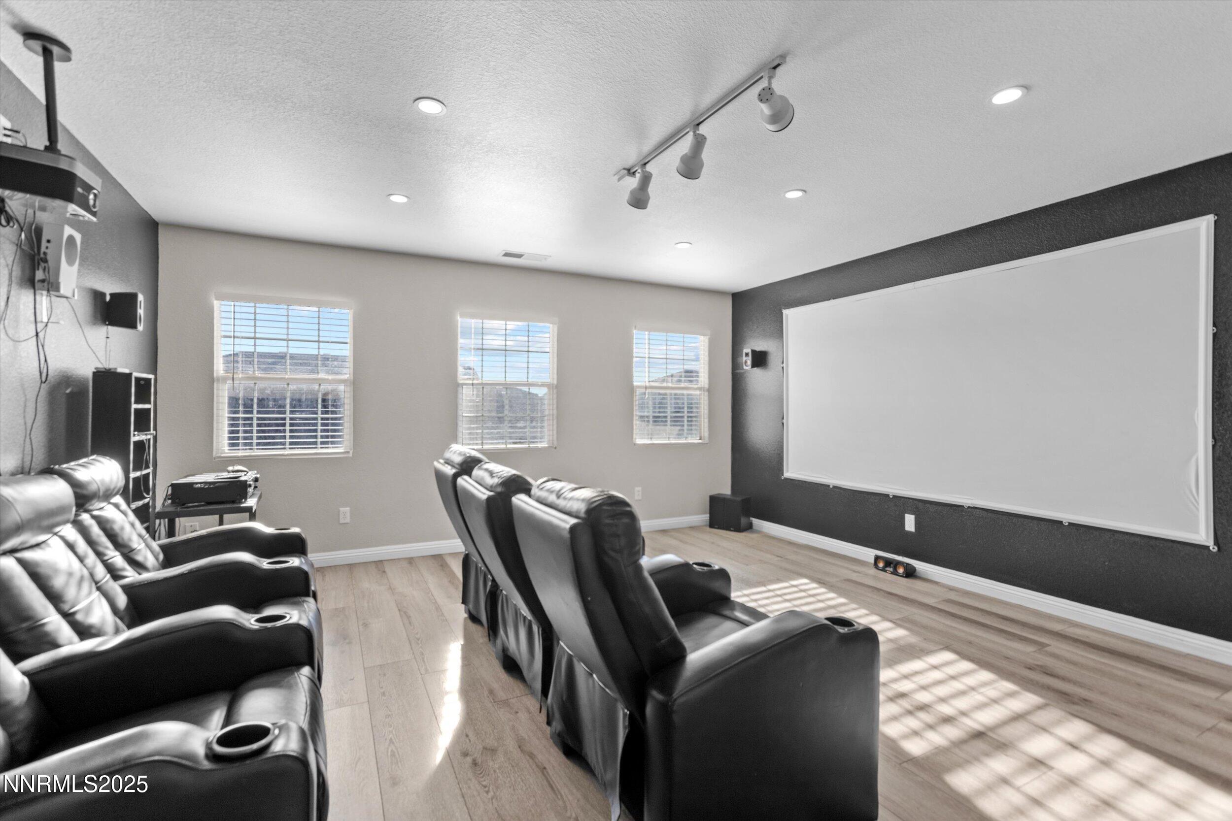8922 Sorcha Street Reno, NV 89506 - Photo 26 of 47 a living room with furniture and a flat screen tv