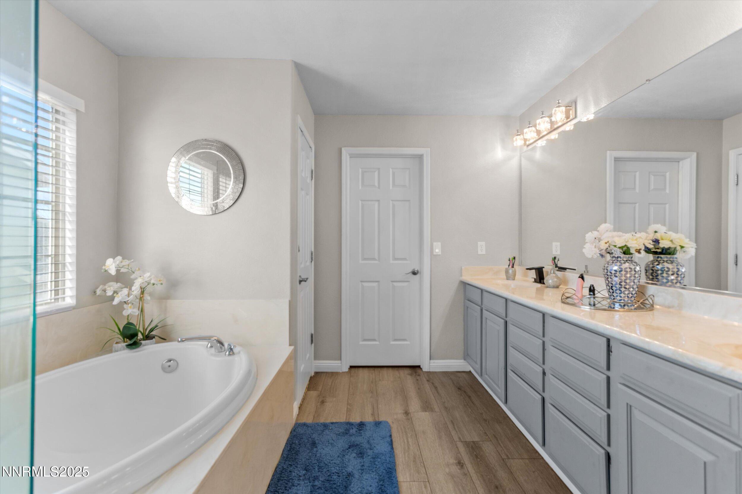 8922 Sorcha Street Reno, NV 89506 - Photo 29 of 47 a bathroom with a tub sink and mirror