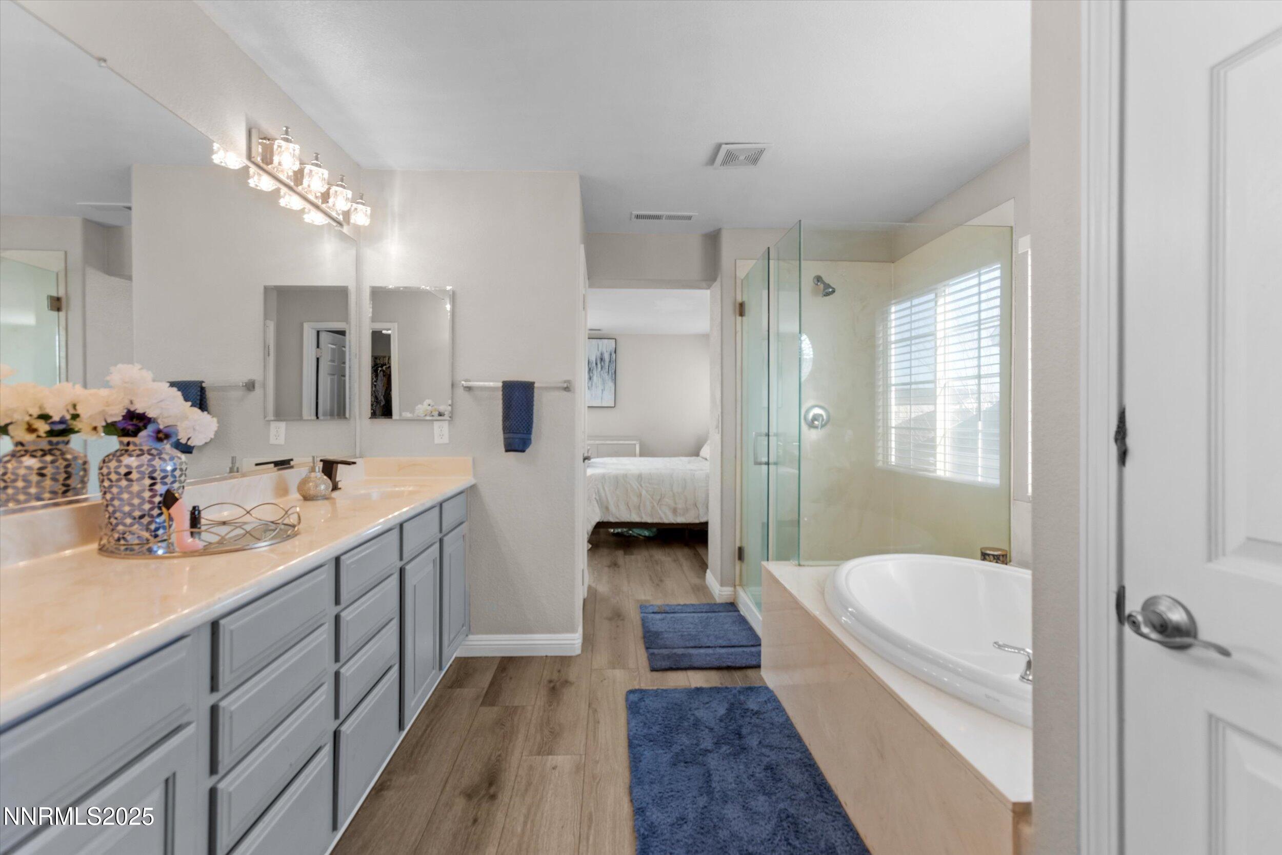 8922 Sorcha Street Reno, NV 89506 - Photo 31 of 47 a bathroom with a tub double vanity sink and mirror