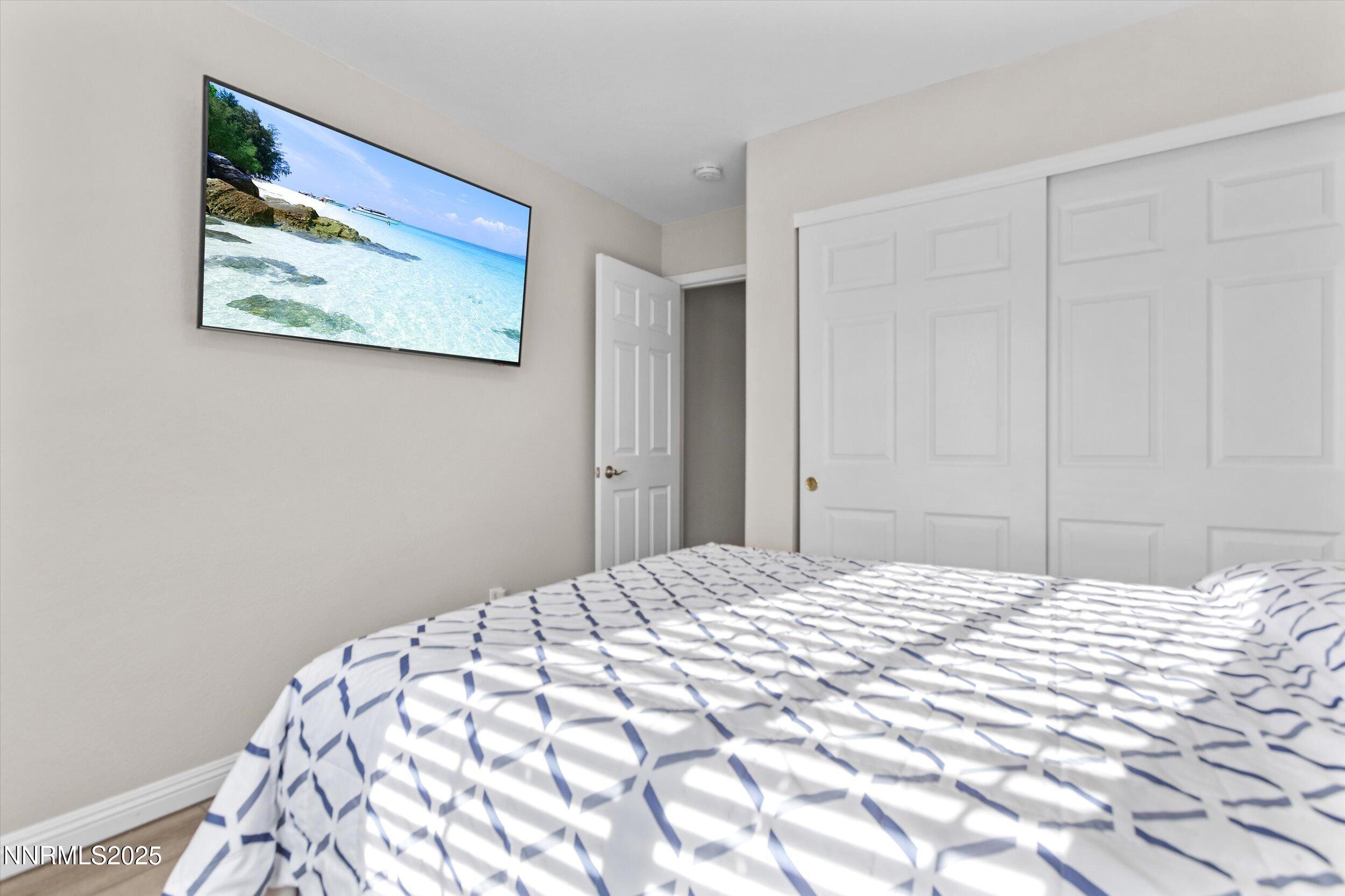 8922 Sorcha Street Reno, NV 89506 - Photo 33 of 47 a bedroom with a bed and a painting on the wall