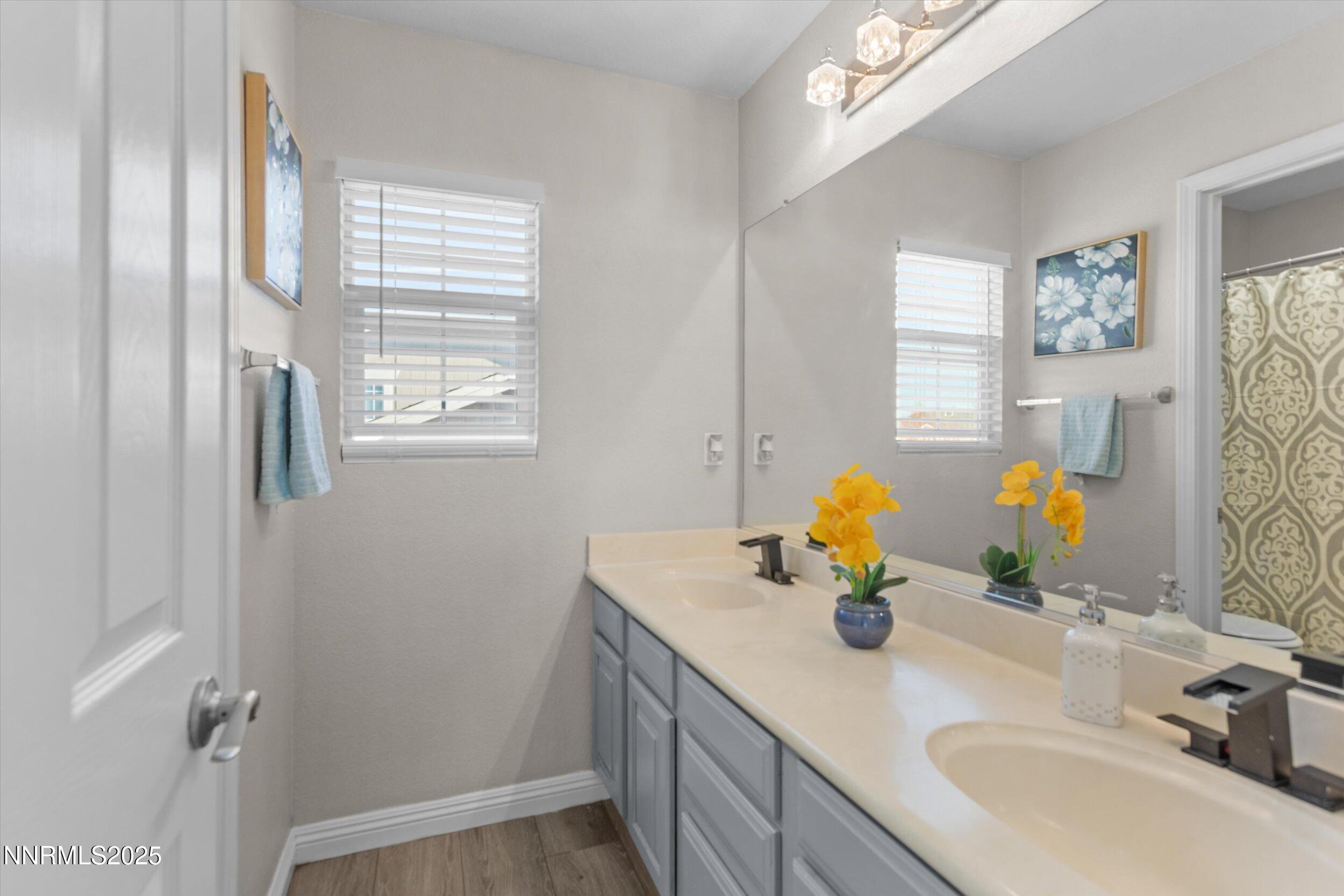 8922 Sorcha Street Reno, NV 89506 - Photo 35 of 47 a bathroom with a sink double vanity and a mirror