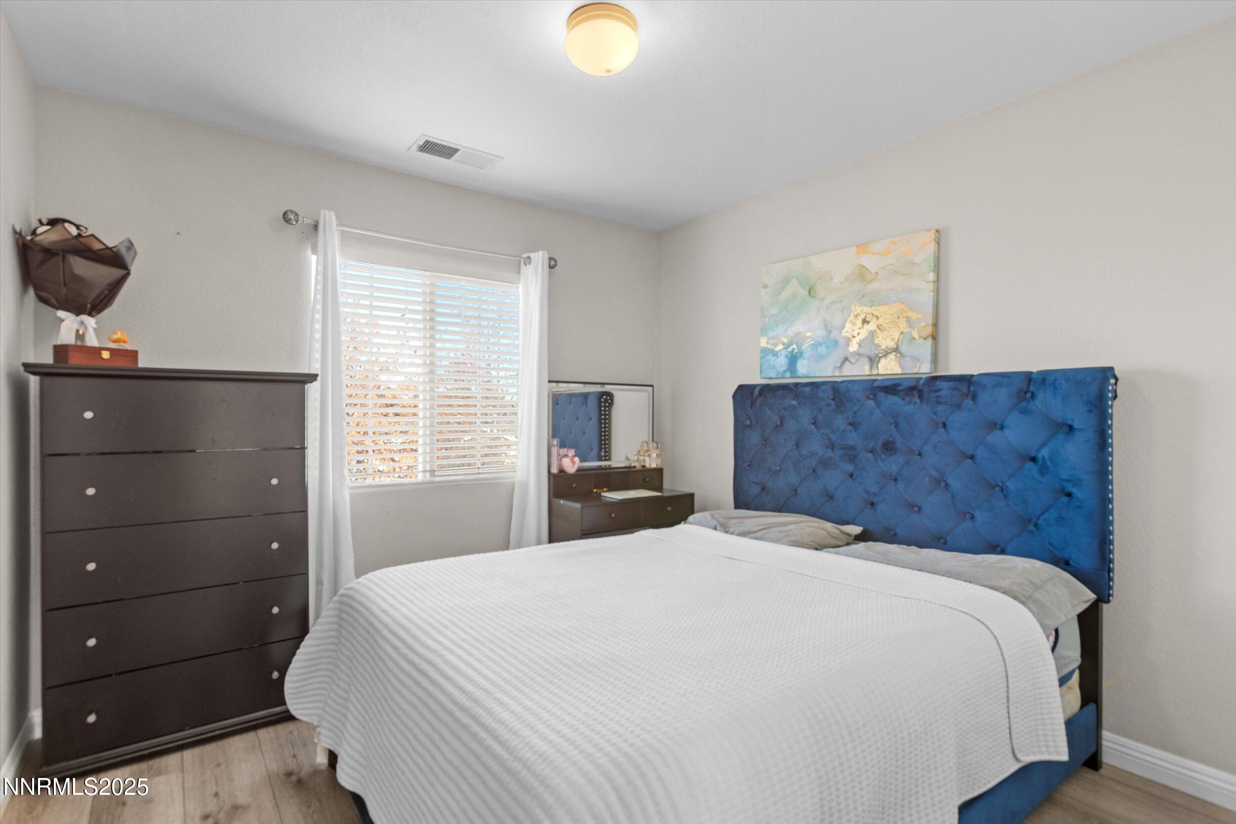 8922 Sorcha Street Reno, NV 89506 - Photo 36 of 47 a bedroom with a bed and a window