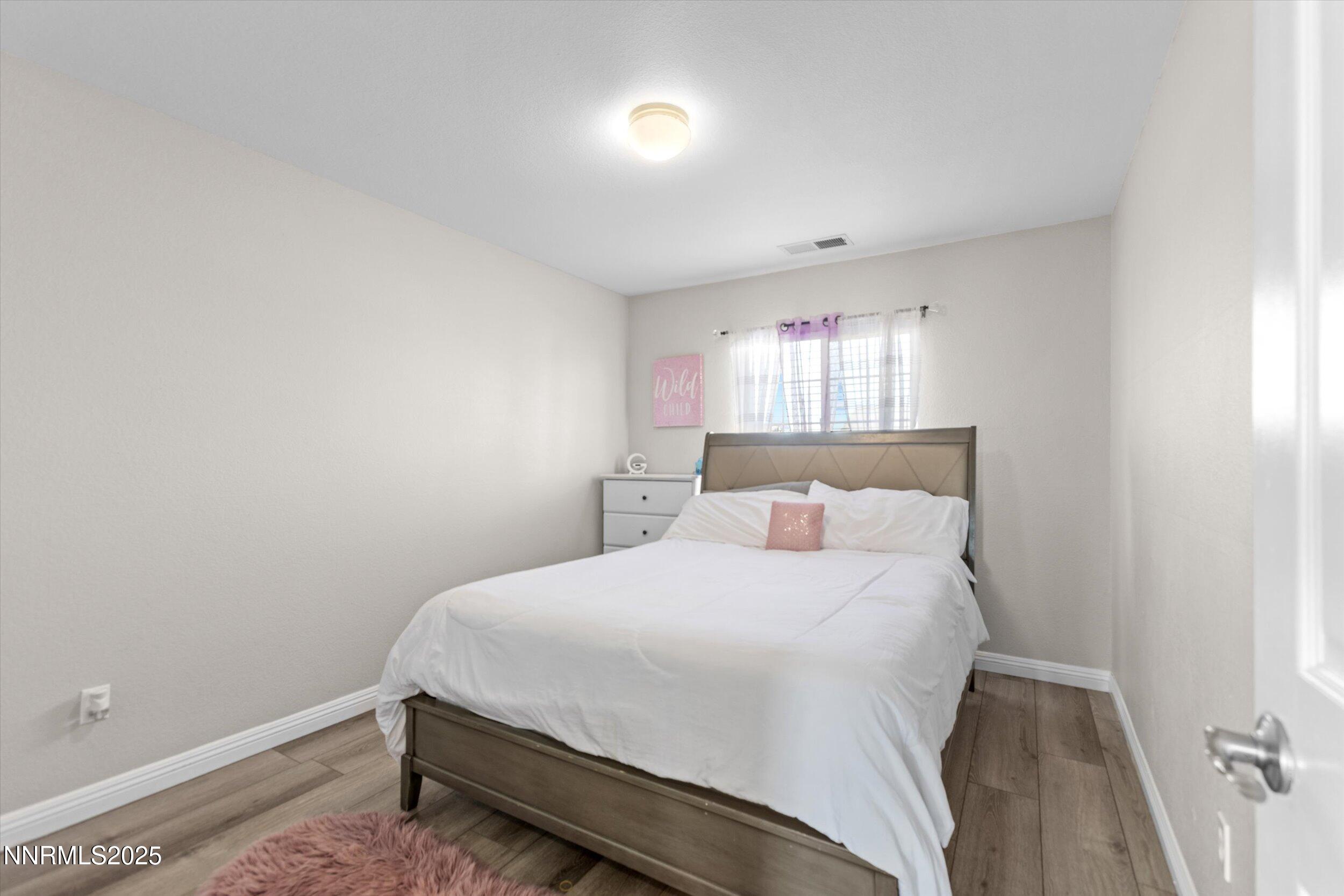 8922 Sorcha Street Reno, NV 89506 - Photo 38 of 47 a bedroom with a bed and a window